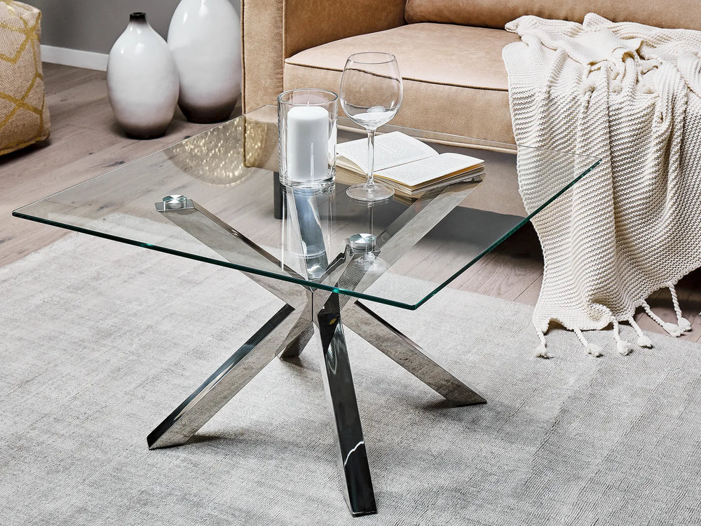 Glass coffee table with metal legs in a living room setting