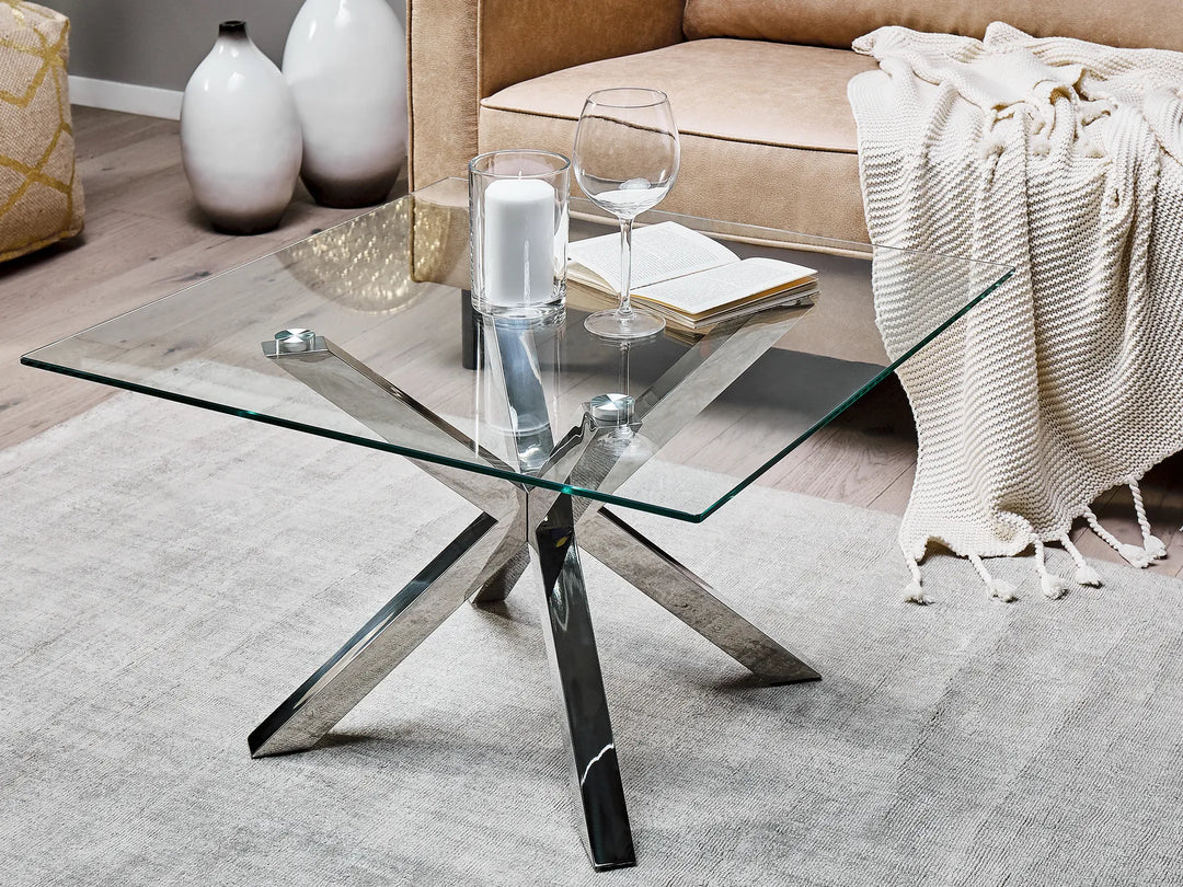 Glass coffee table with metal legs in a living room setting