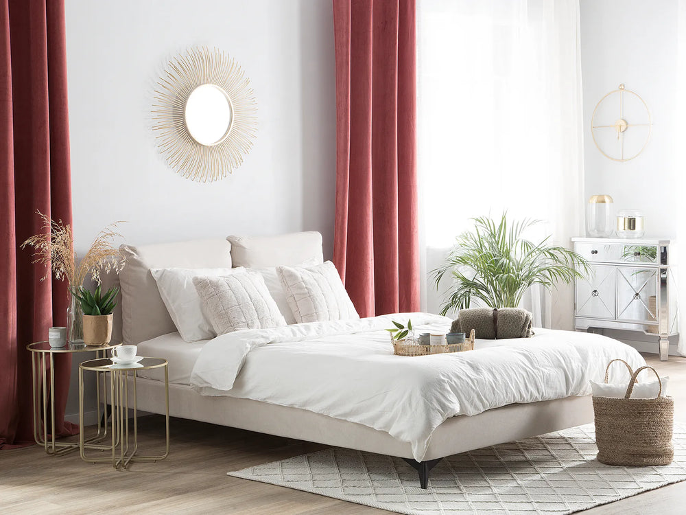 Modern bedroom with white bed, red curtains, and decorative elements.