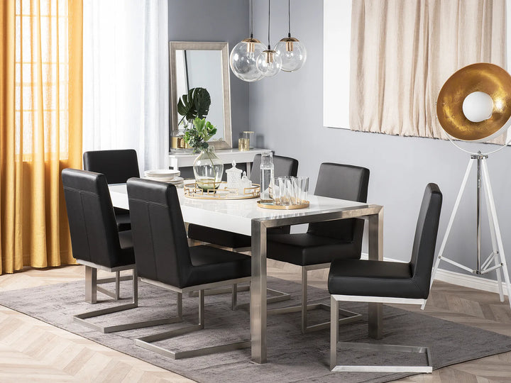 Dining room with a table and chairs in a modern interior setting.