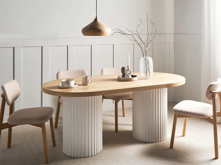 Dining room with a wooden table and chairs in a modern interior setting.