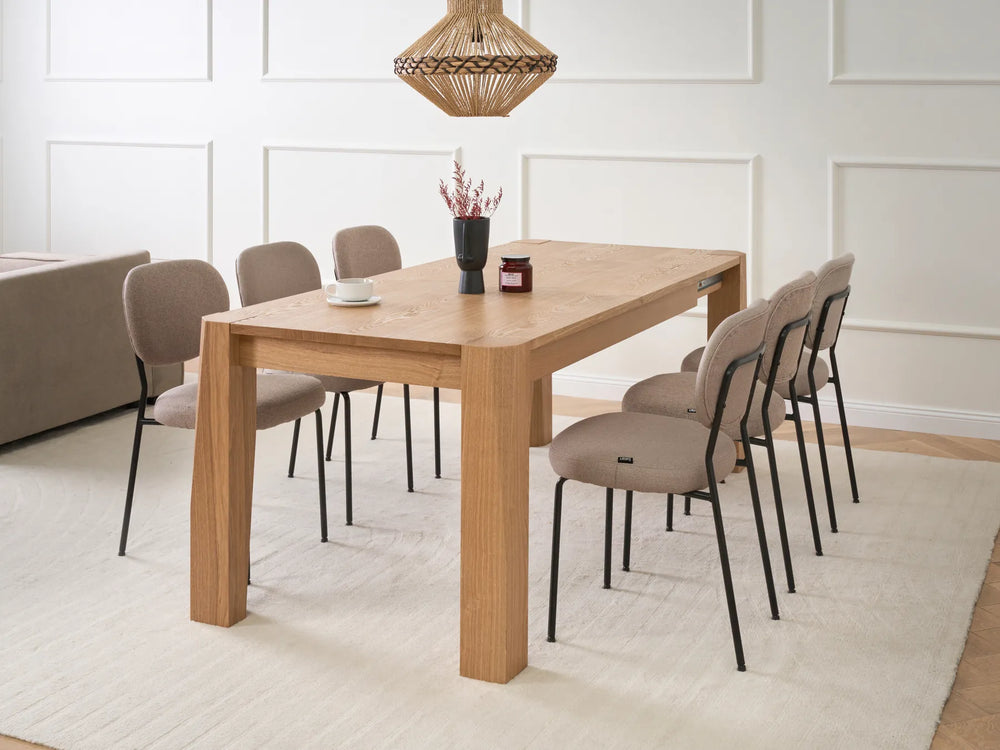 Dining room with a wooden table and chairs in a modern interior setting.