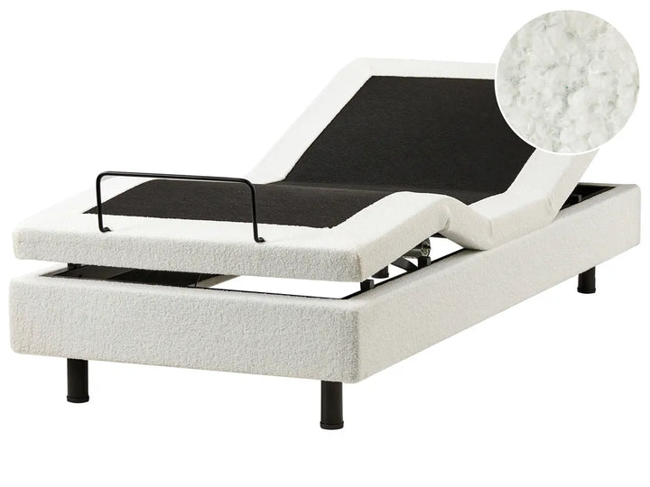 White adjustable bed with black mattress on a white background