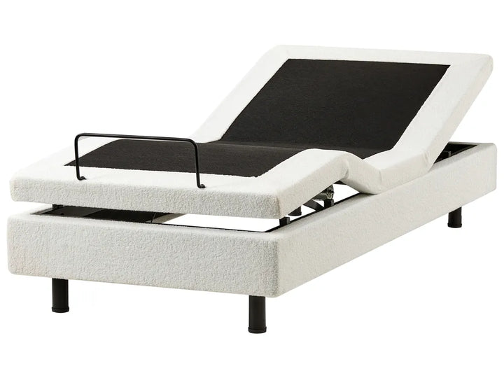 White adjustable bed base with black control panel on a white background