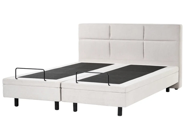 White upholstered bed with black mattress on a white background