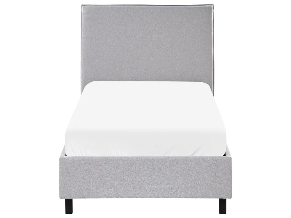 Gray upholstered bed with a white mattress on a white background