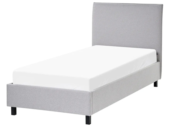 Gray upholstered bed with white mattress on a white background