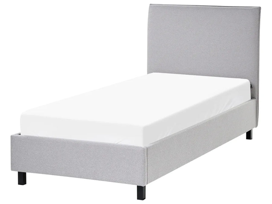Gray upholstered bed with white mattress on a white background
