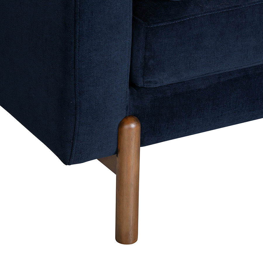 Navy blue sofa with wooden leg on a white background