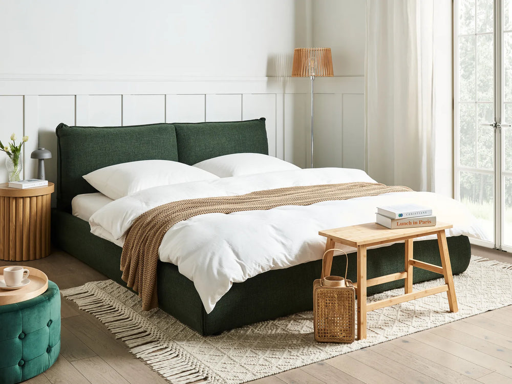 Upholstered bed with soft dark green fabric finish
