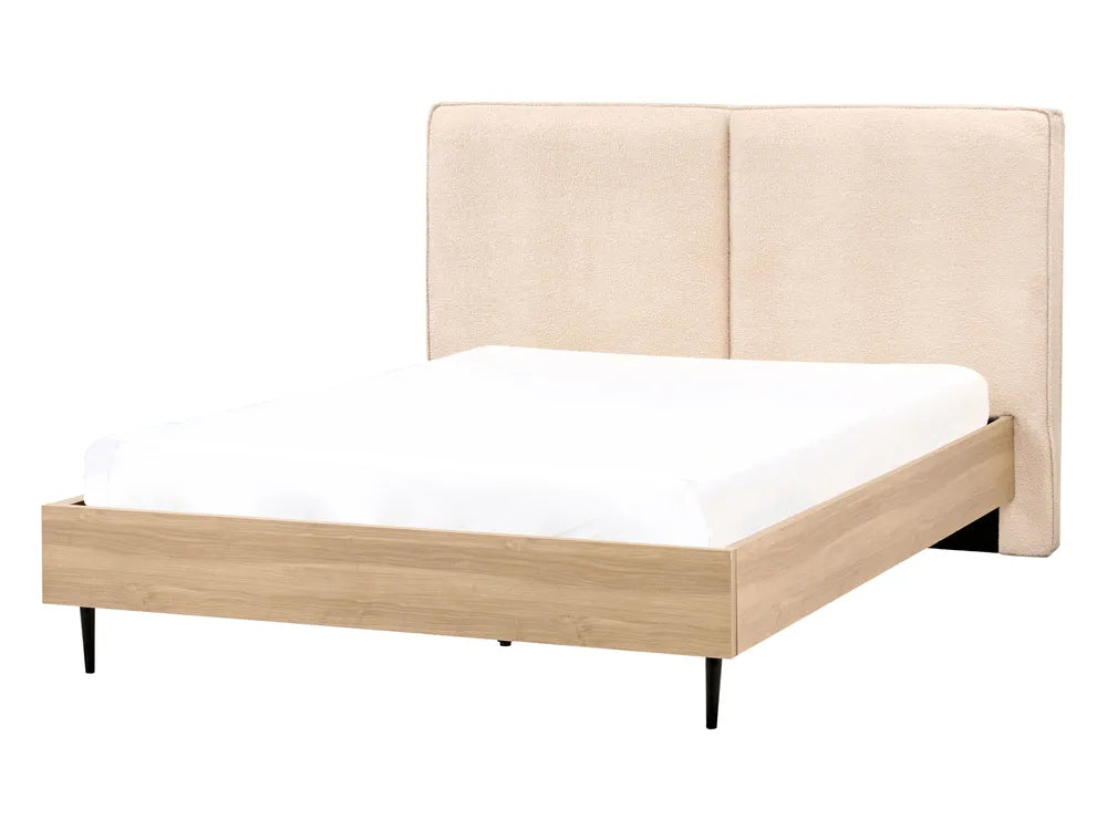 Beige upholstered bed with white mattress on a white background