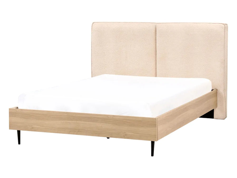 Beige upholstered bed with white mattress on a white background