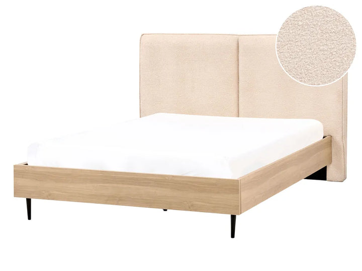 Beige upholstered bed with white mattress on a white background