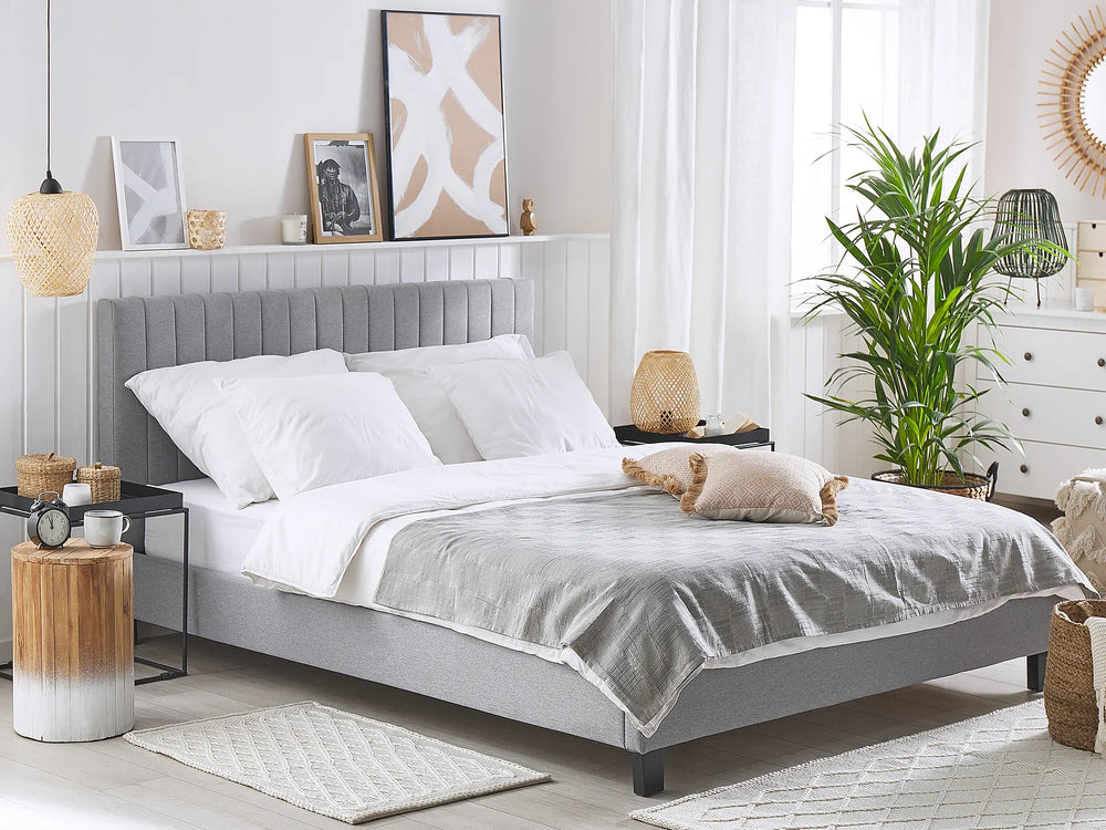 Neatly made bed in a bedroom with decorative elements.
