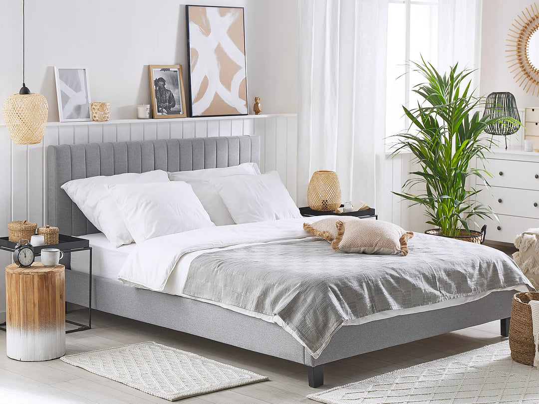 Neatly made bed in a bedroom with decorative elements.