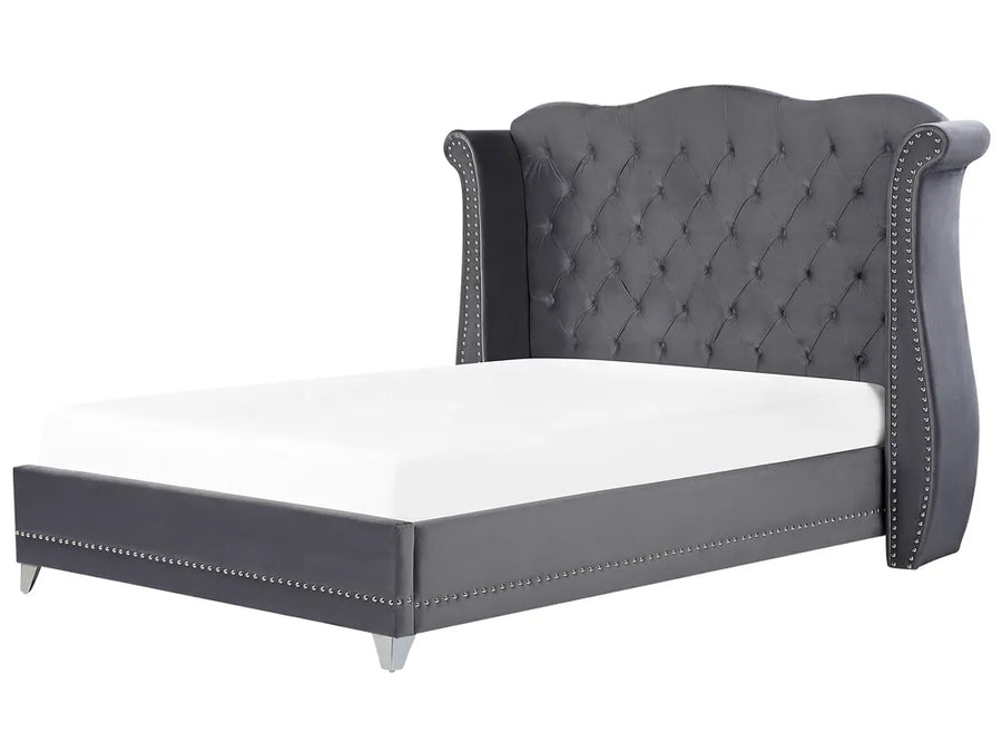 Gray upholstered bed with tufted headboard on a white background