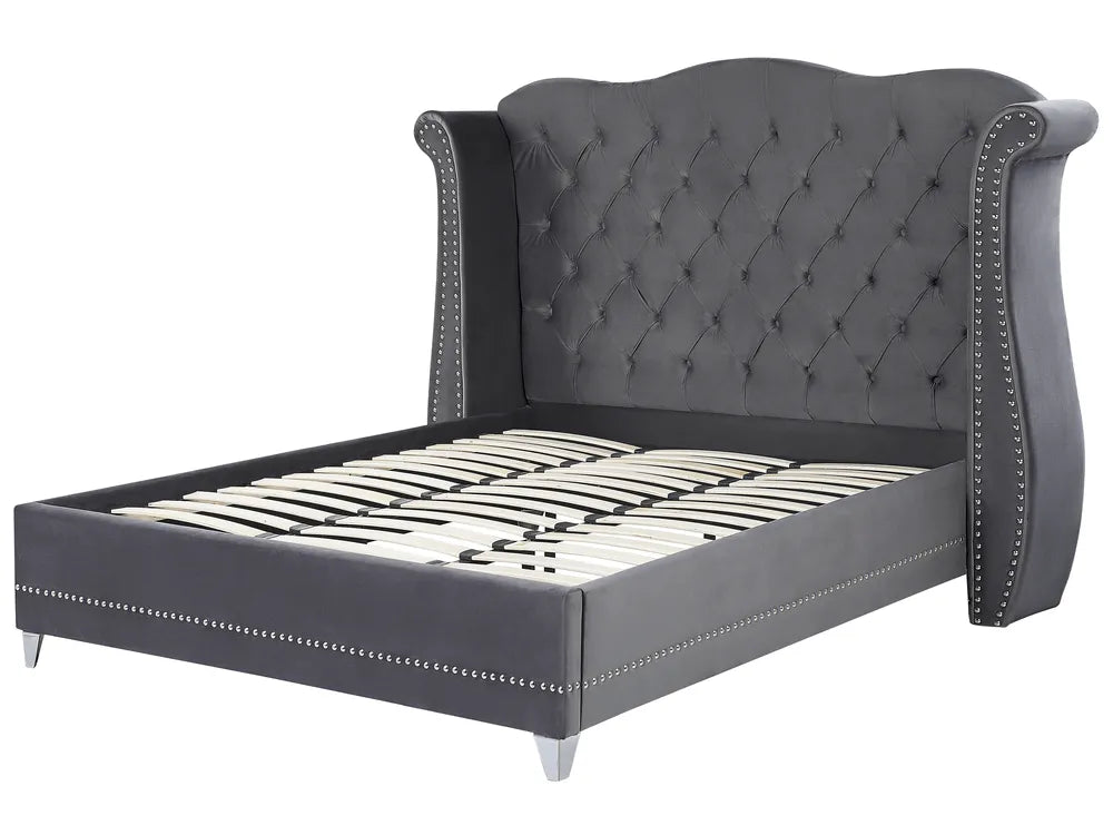 Gray upholstered bed with tufted headboard on a white background