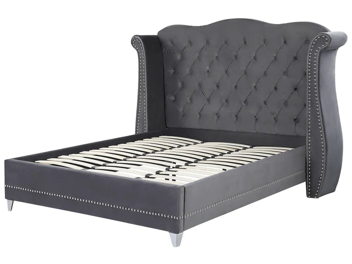 Gray upholstered bed with tufted headboard on a white background