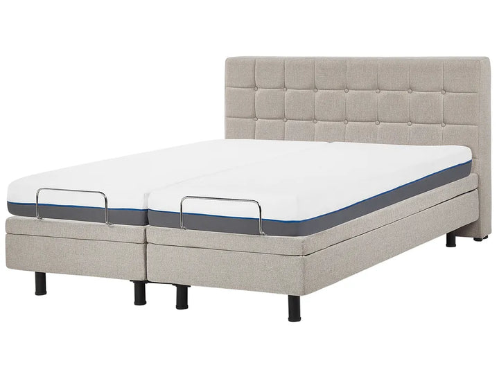 Gray adjustable bed with mattress on a white background