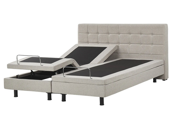 Adjustable bed with tufted headboard on a white background