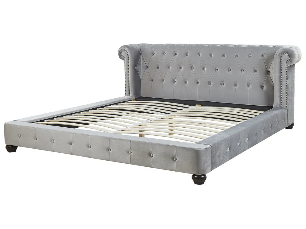 Gray upholstered bed with tufted headboard on a white background