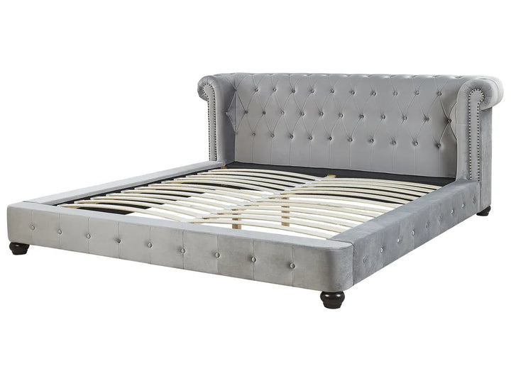 Gray upholstered bed with tufted headboard on a white background