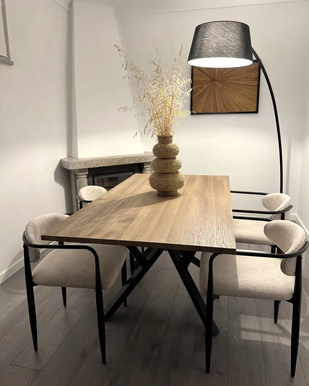 Dining room with wooden table, chairs, and decorative elements.