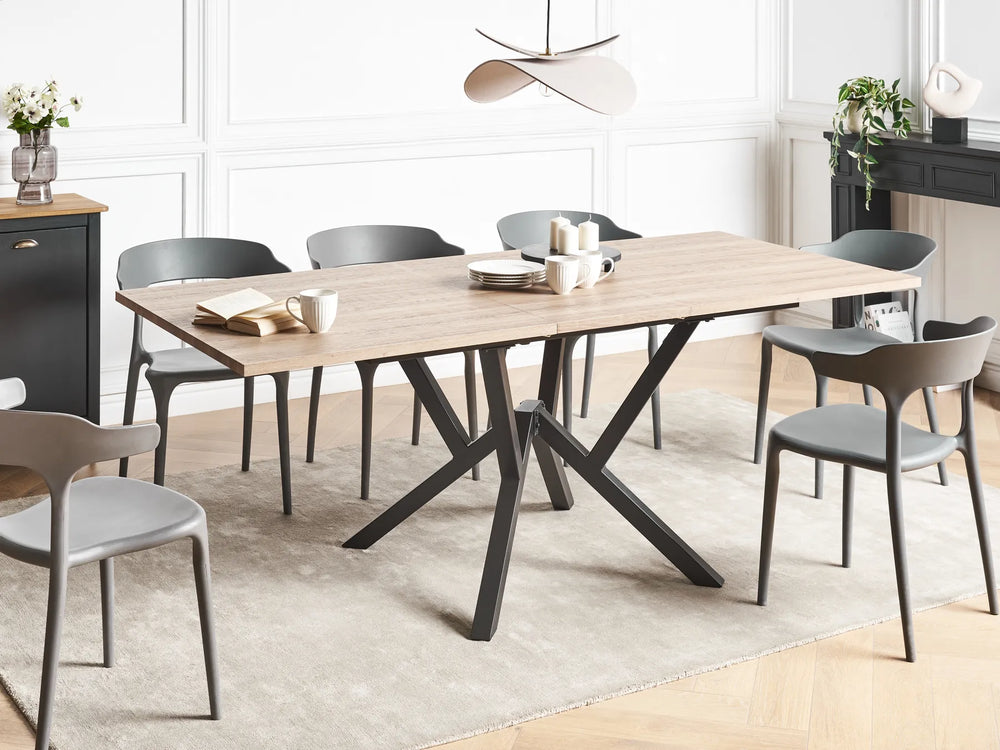 Dining room with a wooden table and gray chairs in a modern interior setting.