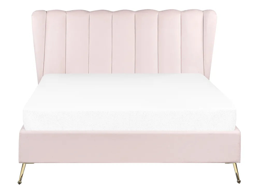 Pink upholstered bed with white bedding on a white background