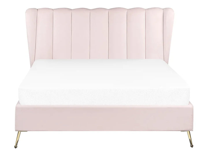 Pink upholstered bed with white bedding on a white background