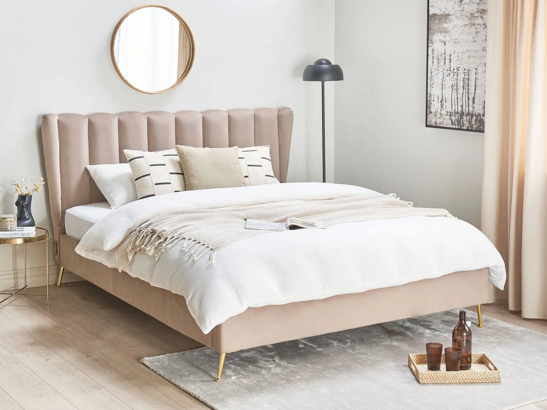 Beige upholstered bed in a modern bedroom with white bedding and decorative pillows.