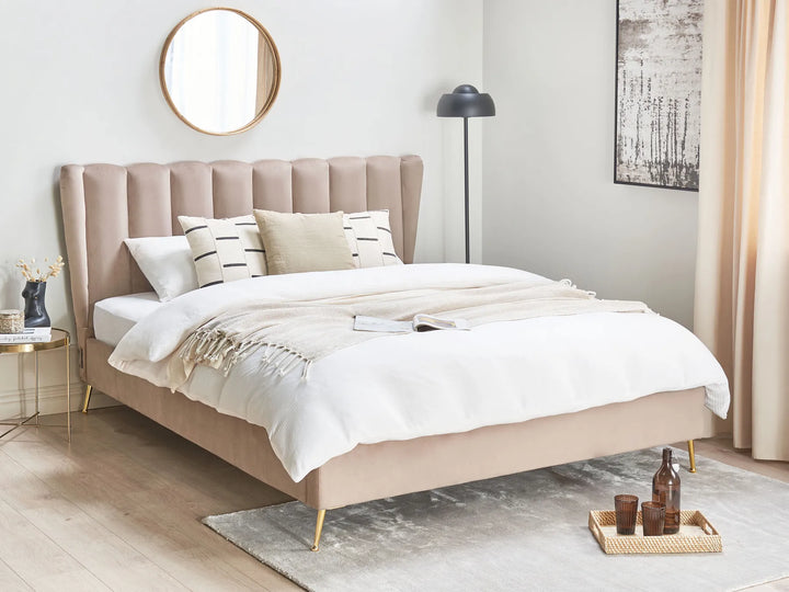 Beige upholstered bed in a modern bedroom with white bedding and decorative pillows.