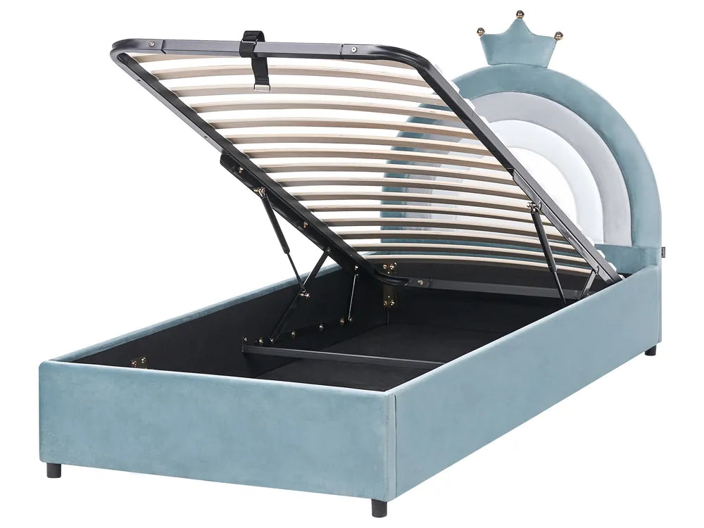 Blue children's bed with metal frame and toy castle in the background