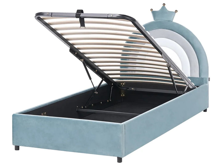 Blue children's bed with metal frame and toy castle in the background