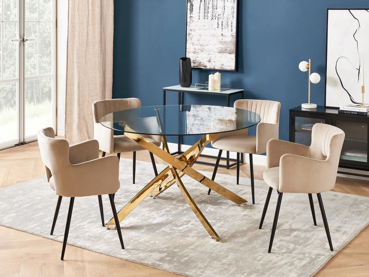 Dining room with a glass table and beige chairs against a blue wall.