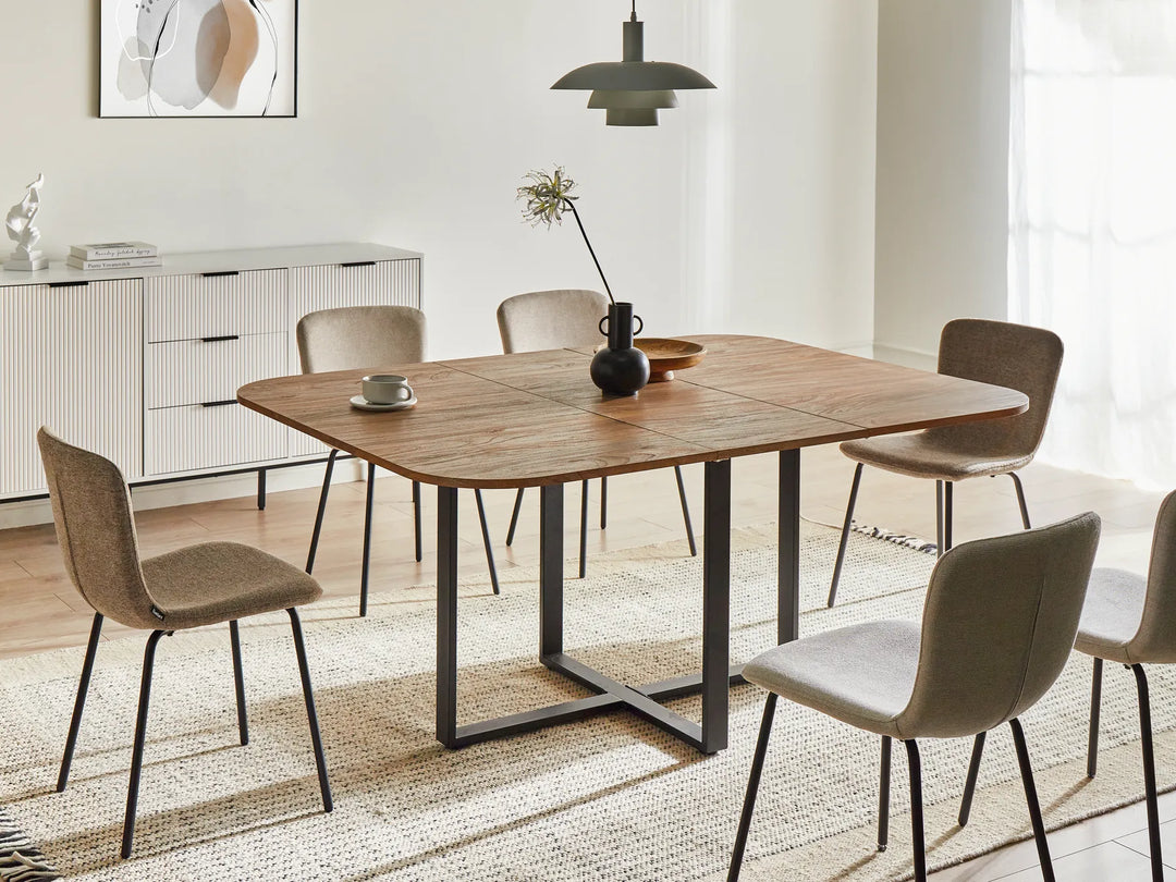Dining room with a wooden table and chairs in a modern interior setting.