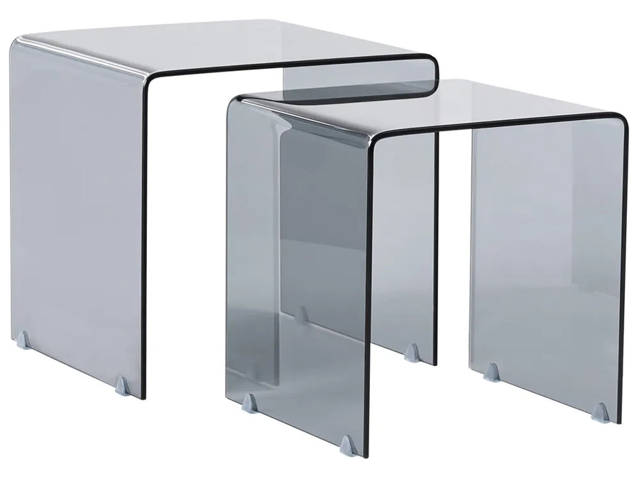 Set of two clear glass nesting tables on a white background