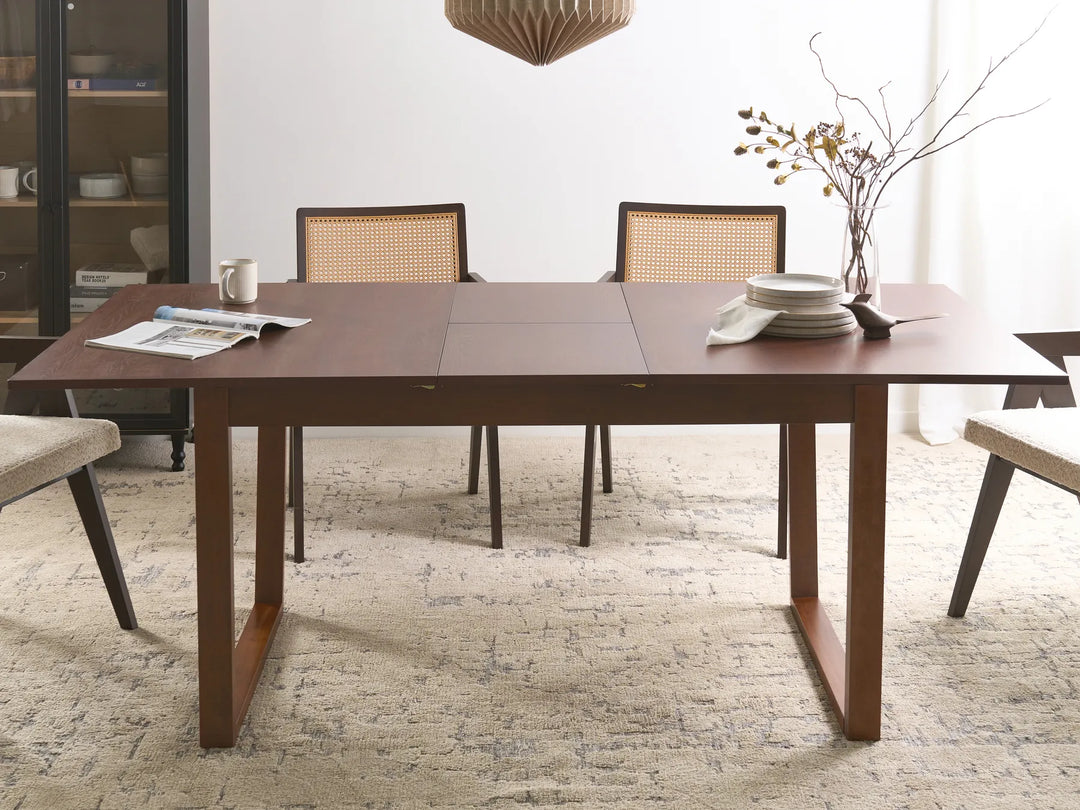 Dining room with a wooden table and chairs on a textured floor.