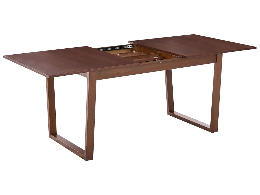 Wooden dining table with an extended leaf on a white background