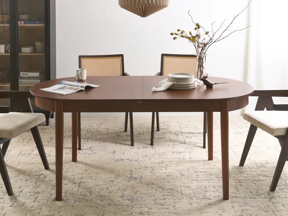 Dining room with a wooden table and chairs on a textured floor.