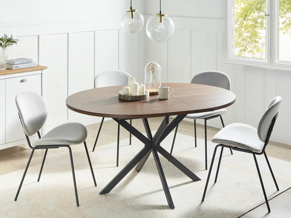 Dining table with four chairs in a bright room