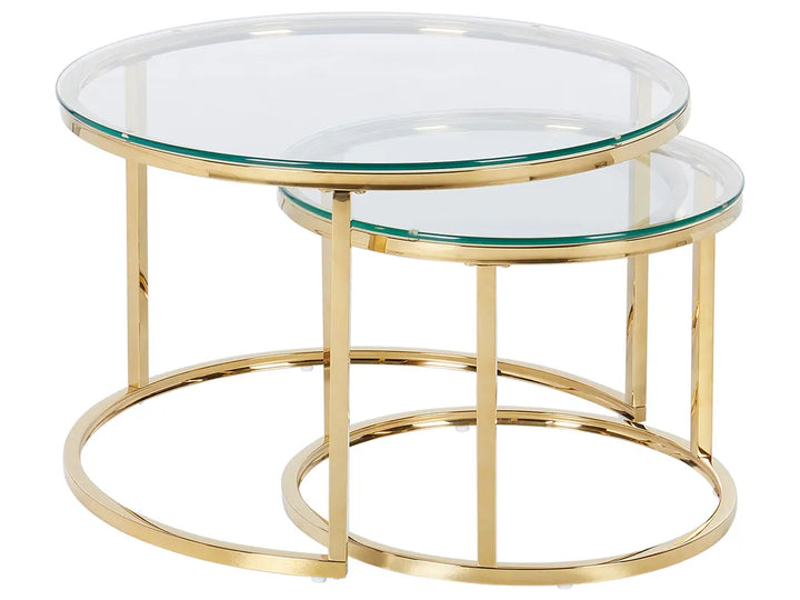 Set of two gold-framed glass tables on a white background