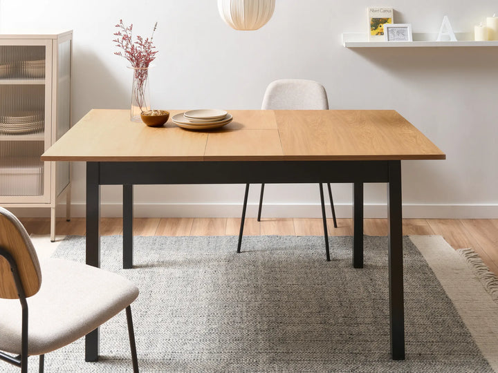 Dining room with a wooden table and chairs on a gray rug.