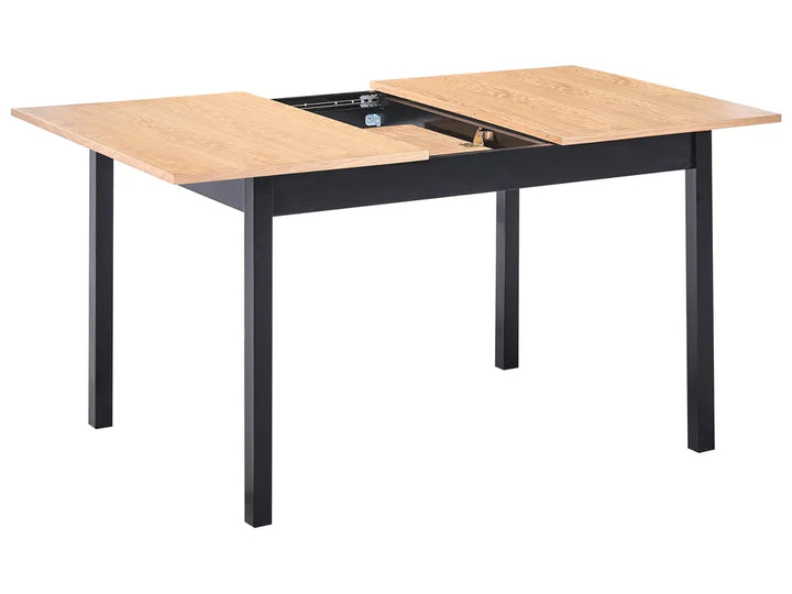 Dining table with wooden top and black metal legs on a white background
