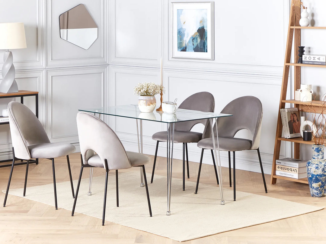 Dining room with a glass table and gray chairs in a well-lit room.