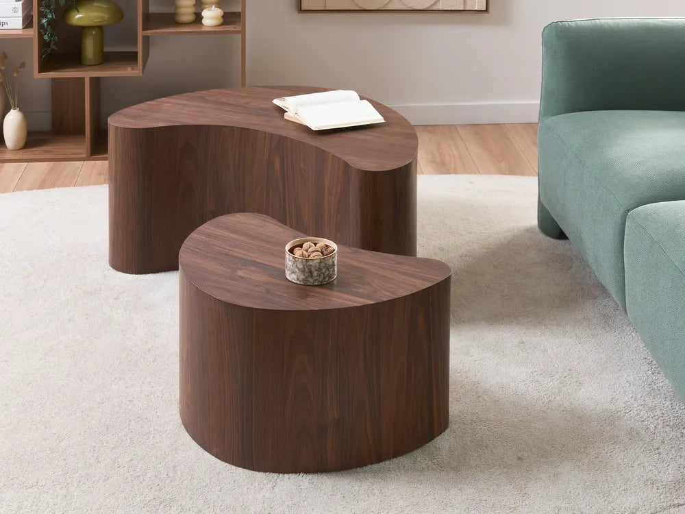 Wooden coffee table with a decorative item on a light-colored rug in a living room setting.