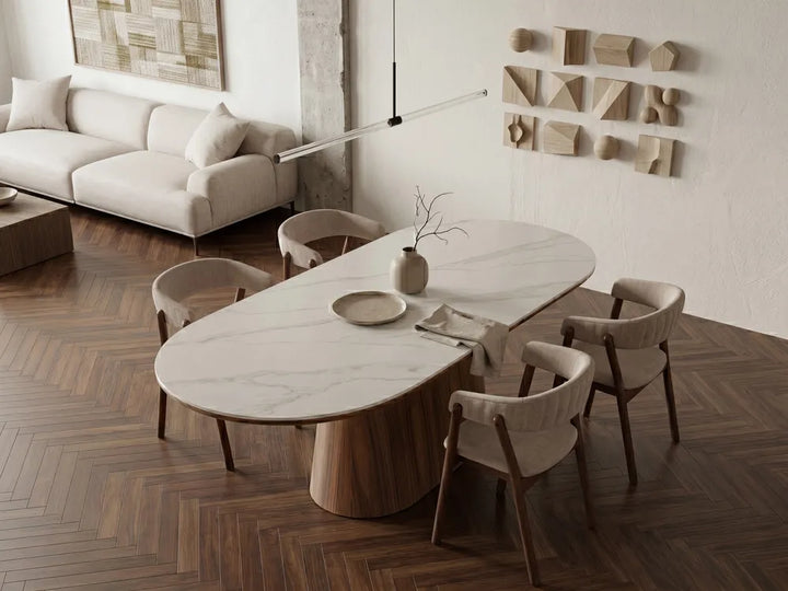 Modern dining room with marble table and chairs in a stylish living area.