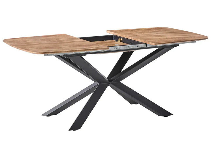 Dining table with wooden top and black metal legs on a white background