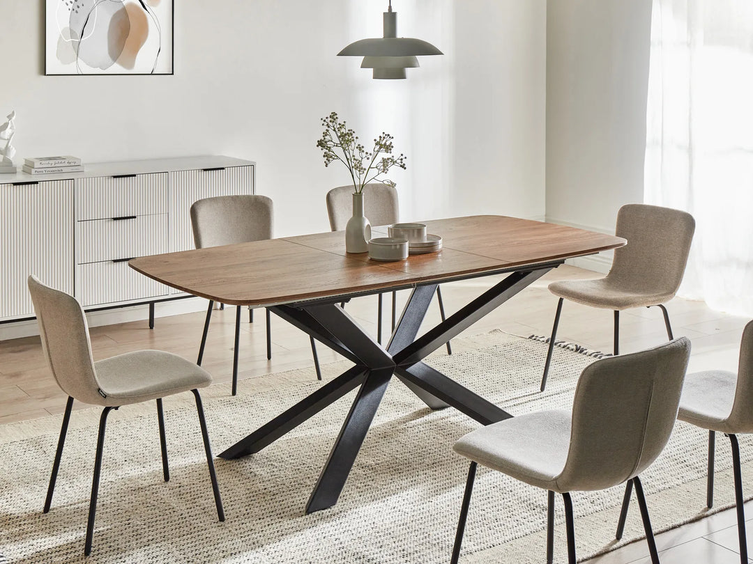 Dining room with a wooden table and chairs in a modern interior setting.