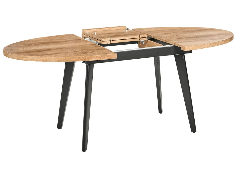 Wooden dining table with black metal legs on a white background